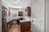 Charming kitchen featuring elegant wooden cabinetry, stainless steel appliances, and abundant natural light. Clermont Condominiums apartments in East Walnut Hills, Cincinnati, OH.