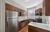 Modern kitchen with sleek stainless steel appliances, rich wood cabinetry, and ample natural light. Clermont Condominiums apartments in East Walnut Hills, Cincinnati, OH.