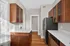 Bright and modern kitchen with sleek stainless steel appliances, elegant wooden cabinetry, and smooth quartz countertops. Apartments in East Walnut Hills Clermont Condominiums
