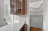 Charming kitchen nook with elegant wooden cabinetry, sleek white countertops, and a corner pantry for ample storage. Clermont Condominiums