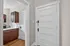 Charming entryway with elegant wooden floors leading to a sleek kitchen with rich wood cabinetry and bright natural lighting. Apartments in East Walnut Hills, Clermont Condominiums