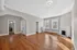 Bright and inviting living room featuring elegant hardwood floors, ample natural light, and a classic white fireplace. Apartments in East Walnut Hills, Clermont Condominiums