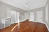 Bright and inviting room with elegant hardwood floors, classic white doors, and a ceiling fan, offering a charming blend of style and comfort. Clermont Condominiums apartments in East Walnut Hills.