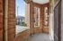 Charming brick-enclosed patio overlooking a quiet street with lush greenery and classic urban architecture. Clermont Condominiums apartments in East Walnut Hills.