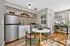 Chic apartment kitchen and dining area with modern appliances, elegant decor, and inviting natural light.
