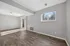Bright and inviting living room with elegant wood flooring, ample sunlight through large windows, and seamless outdoor access.