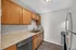 Modern kitchen featuring sleek stainless steel appliances, elegant wood cabinetry, and chic subway tile backsplash.