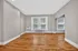 Bright and open living space featuring elegant hardwood floors and large windows for natural light.