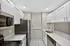 Bright and modern kitchen featuring sleek white cabinetry, polished countertops, and stainless steel appliances.