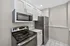 Modern kitchen with sleek stainless steel appliances and elegant white cabinetry.