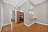 Charming open-concept apartment with elegant wood flooring, featuring a modern kitchen with granite countertops and stainless steel appliances.