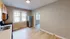 Contemporary kitchen with stainless steel appliances and large windows offering natural light.