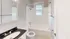 Bright bathroom featuring modern fixtures, a bathtub, and stylish tile flooring.