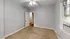 Inviting bedroom with neutral tones, carpet flooring, and a window with AC unit.