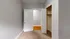 Bright room with grey walls, carpeted floor, and open doorway to a walk-in closet.
