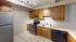 Well-appointed kitchen with wooden cabinetry, modern appliances, and tiled flooring.