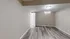Bright empty room with stylish wood flooring and neutral walls.