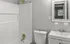 Sleek bathroom featuring a modern shower, large mirror, and stylish sink.