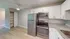 Stylish kitchen with stainless steel appliances, granite countertops, and white cabinetry.