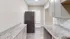 Modern kitchen with granite countertops, stainless steel fridge, and elegant cabinetry.