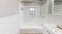 Bright bathroom with classic white tiles, a window above the tub, and a modern faucet.