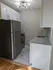 Modern kitchen with stainless steel appliances, granite countertops, and elegant lighting.