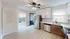 Bright and modern kitchen with sleek stainless steel appliances, white cabinetry, and a geometric backsplash design.