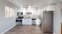 Modern kitchen with sleek stainless steel appliances, white cabinetry, and granite countertops offering a bright and inviting cooking space.