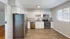 Modern kitchen with sleek stainless steel appliances, elegant granite countertops, and white cabinetry.