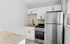 Modern kitchen with sleek stainless steel appliances, granite countertops, and elegant white cabinetry.