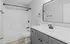Modern bathroom with sleek fixtures, white bathtub, and elegant vanity, offering a clean and serene space, Alcove of Turpin Hills two-bedroom apartment near downtown Cincinnati.