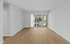 Bright, spacious living area with elegant wood flooring and large sliding glass doors leading to balcony, Alcove of Turpin Hills two-bedroom apartment near downtown Cincinnati.