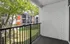 Charming apartment balcony overlooking a serene courtyard with vibrant trees and modern architecture, apartment with private balcony in cincinnati alcove of turpin hills.