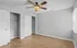 Bright and spacious bedroom featuring fresh paint, wood flooring, ceiling fan, and ample closet space.