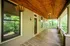 Charming wooden porch with natural surroundings, featuring elegant lighting and cozy ambiance.