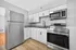 Modern kitchen with sleek stainless steel appliances, granite countertops, and elegant white cabinetry, offering a bright and welcoming culinary space.