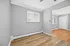 Bright and inviting room with large windows, elegant wooden flooring, and neutral wall colors, perfect for personalization and comfort.