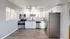 Modern kitchen with sleek stainless steel appliances, bright white cabinetry, and elegant granite countertops.