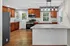 Modern kitchen with elegant granite countertops, sleek stainless steel appliances, and rich wooden cabinetry.