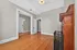 Charming room with elegant wooden flooring, classic white trim, and a cozy fireplace, showcasing timeless architecture.