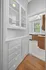 Charming kitchen space featuring elegant cabinetry, polished wooden floors, and abundant natural light.