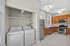 Bright, modern kitchen with stainless steel appliances and in-unit washer and dryer, featuring elegant cabinetry and large windows for plenty of natural light.