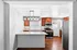 Modern kitchen with elegant pendant lighting, stainless steel appliances, and rich wooden cabinets.