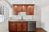 Inviting kitchen area with elegant wood cabinets, sleek granite countertops, and modern stainless steel appliances.