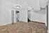 Bright and inviting room with modern tile flooring, freshly painted white walls, and a ceiling light fixture, ideal for a cozy living space.