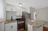 Modern kitchen with sleek granite countertops, stainless steel appliances, and elegant cabinetry, perfect for a stylish apartment.