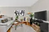 Contemporary living room with sleek furniture, abstract art, and cozy accents in neutral tones.