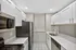 Sleek modern kitchen featuring stainless steel appliances, white cabinetry, and elegant countertops.
