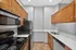 Modern kitchen with stainless steel appliances, sleek countertops, and ample wooden cabinetry for a stylish culinary space.