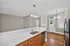 Charming kitchen area featuring modern lighting, sleek countertops, and warm wood flooring, creating a welcoming atmosphere.